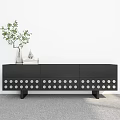 Black TV Stand With White Circular Dots And Green Plant Vase Decorative Item Books