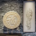 Ornament Decoration Set Featuring Circular Carved Fu Symbol Hanging Rock Art On Gray Brick Wall