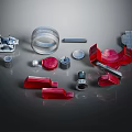 Various Mechanical Parts Including Metal Components Red Plastic Accessories And Transparent Cylinders