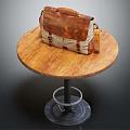 Vintage Brown And Beige Leather Bag On Wooden Round Table With Metal Base