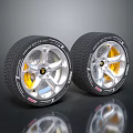 Two High Performance Tires With Silver Alloy Wheel Rims And Yellow Brake Calipers