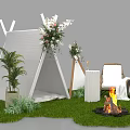 Outdoor Camping Setting with White Tepee Flower Arrangements Bonfire and Chair on Green Grass