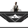Woman Standing By Yongjie Wujian Display Table With Black Surface And Plants
