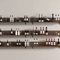 Three Wooden Shelves with Wine Bottles and Glasses on Light Colored Wall