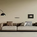 Modern Three Seater Sofa With Beige Upholstery Mixed Pattern Cushions And Black Floor Lamp
