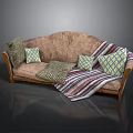 Brown Sofa With Various Patterned Pillows And Striped Blanket On Wooden Armrests