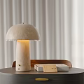 Mushroom Shaped Concrete Table Lamp With Warm Light And Decorative Boxes On Wooden Table