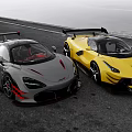 Gray And Yellow Sports Cars With Rear Spoilers On Asphalt Road