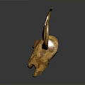 Golden Decorative Animal Skull with Curved Horns and Red Gemstone on Forehead