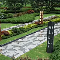 Neatly Trimmed Garden Shrubs Along Stone Pathway With Green Lawn And Decorative Lamps