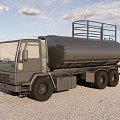 Silver Tanker Truck with Metal Rails on Sandy Ground Under Blue Sky