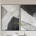 Black And White Abstract Paintings Hanging On Wall With Green Plant And Vase