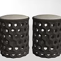 Two Black Stools With Hexagonal Cutout Design And Light Colored Padded Top 3d model