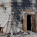 Burned Building Exterior With Damaged Walls Broken Windows Fallen Bricks And Debris At Entrance