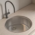 Modern Stainless Steel Kitchen Sink With Black Faucet On Light Countertop