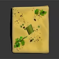 Yellow Cube Shaped Food With Green Herbs And Olive Topping On Textured Surface