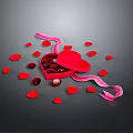 Red Heart Shaped Box With Chocolates And Pink Ribbon Surrounded By Rose Petals