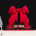 Giant Red Bow Installation With Silhouette People Red More Text Surrounded By Red Flowers