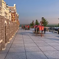 Traditional Commercial Street With Brick Buildings Stone Paved Walkway Red Canopies Street Lamps And Pedestrians