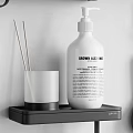 Modern Bathroom Accessories Organized On Wall Shelves With Bottles Towel And Toiletries