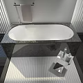 Modern Bathroom Interior With Oval White Bathtub Granite Countertop And Chrome Faucet