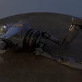 Damaged Intelligent Machine Lying on Sandy Ground With Broken Mechanical Parts and Metallic Body