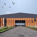 Large Industrial Plant Red Brick Facade Entrance Pedestrians Green Plants Birds in Sky