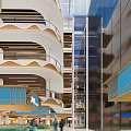 Spacious Shopping Mall Lobby With Wide Corridors Wooden Ceiling Escalators And Pedestrians