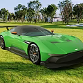 Green Sports Car Parked On Lush Grass Field With Sleek Aerodynamic Design And Black Accents