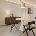 Modern Restaurant Interior With White Round Dining Table Wooden Cabinet And Hanging Lamp