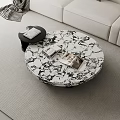Modern Round Marble Coffee Table With Books And Black Side Table In Living Room