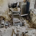 Fire Damaged Kitchen Interior Showing Burned Walls Broken Appliances And Debris