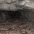 Cave Interior Scene With Rocky Overhang Rock Walls And Stone Floor Debris