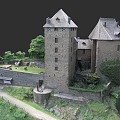 Medieval European Castle with Tall Towers and Stone Walls Surrounded by Green Lawns and Trees