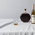 Two Glass Wine Bottles And Whiskey Glass With Drink On White Tablecloth