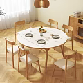 Round White Dining Table Set With Wooden Legs And Six Chairs With White Cushions