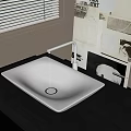 White Rectangular Vessel Sink with White Faucet on Black Countertop and Wall Art
