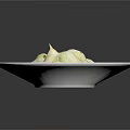 Creamy White Ravioli in Rich Sauce Garnished with Fresh Green Herbs on White Plate