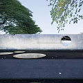 Urban Garden Landscape With Dark Paved Pathway Lush Trees And Central Water Feature