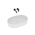 White Oval Countertop Washbasin with Black Faucet on Grey Bathroom Countertop