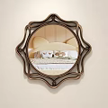 Ornate Round Wall Mirror with Decorative Bronze Frame Reflecting Bedroom Bed and Nightstand