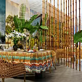 Tropical Restaurant Interior With Bamboo Screens Green Plants Rattan Furniture And Colorful Tablecloths