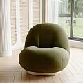Cozy Green Velvet Single Sofa with Rounded Design in Interior with Wooden Floor and View
