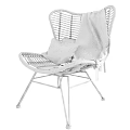 Wicker Lounge Chair With Plaid Pillow And Linen Blanket On Black Metal Frame