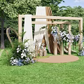 Outdoor Floral Installation With Wooden Frames Hanging White Purple Flowers And Green Grass