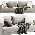 Beige Two Seater Sofa With Soft Gray And White Pillows And Warm Knitted Blanket