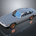 Vintage Silver Gray Car with Sleek Design and Copper Wheels on Dark Background with Reflection