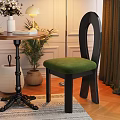 Modern Black Frame Dining Chair With Green Velvet Seat And Unique Curved Back Design