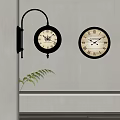 Two Black Decorative Clocks With Roman Numerals On Light Colored Wall
