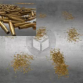 Pile of Brass Bullets Scattered on Ground as Weapon Ammunition Stock